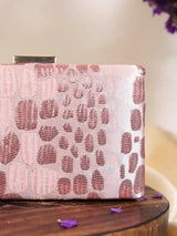 Coral sleek pink clutch bag by The Tan Clan with a smooth, minimalist design and gold-tone clasp.