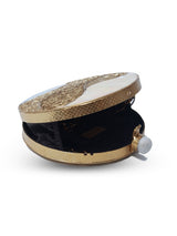Crescent-shaped mother of pearl clutch by The Tan Clan with a shiny, iridescent surface and compact design for elegant occasions.