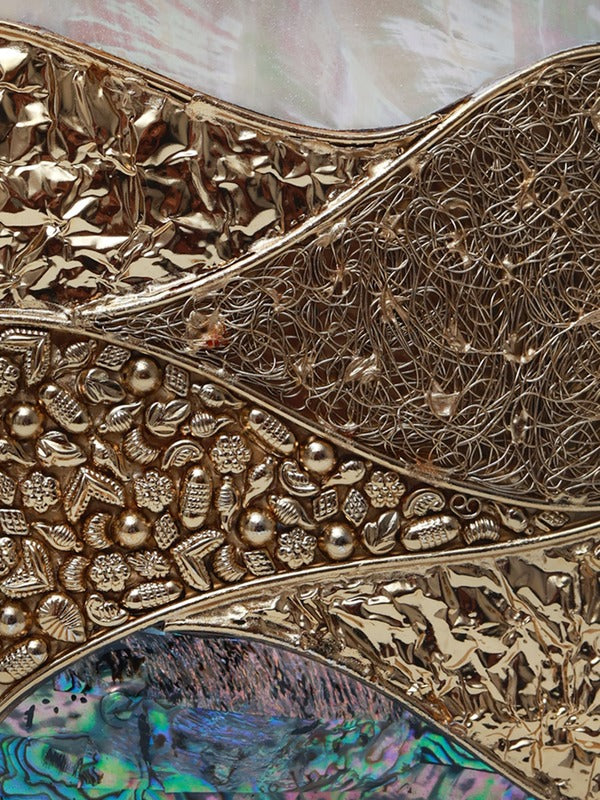 Crescent-shaped round clutch bag with mother of pearl finish by The Tan Clan, featuring a sleek elegant design.