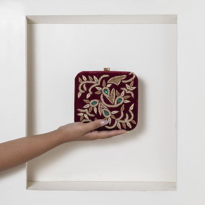 Crimson square hand-embroidered clutch by The Tan Clan with intricate embroidery and elegant design for stylish occasions.
