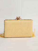Light gold feather embroidered clutch by The Tan Clan featuring intricate hand embroidery and a sleek, elegant design.