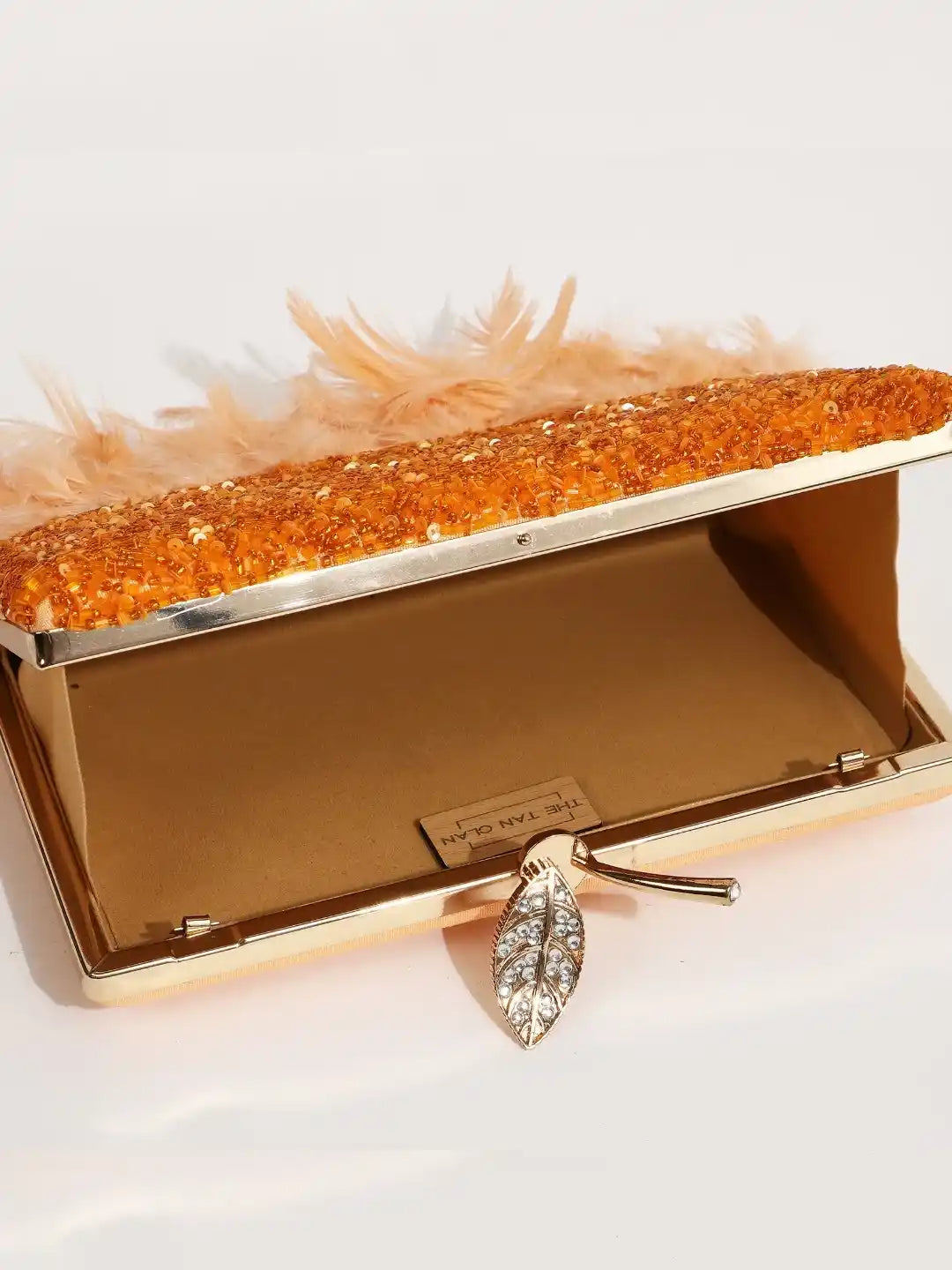 Daina Peach Hand Embroidered Feather Clutch by The Tan Clan, featuring intricate embroidery and feather details.