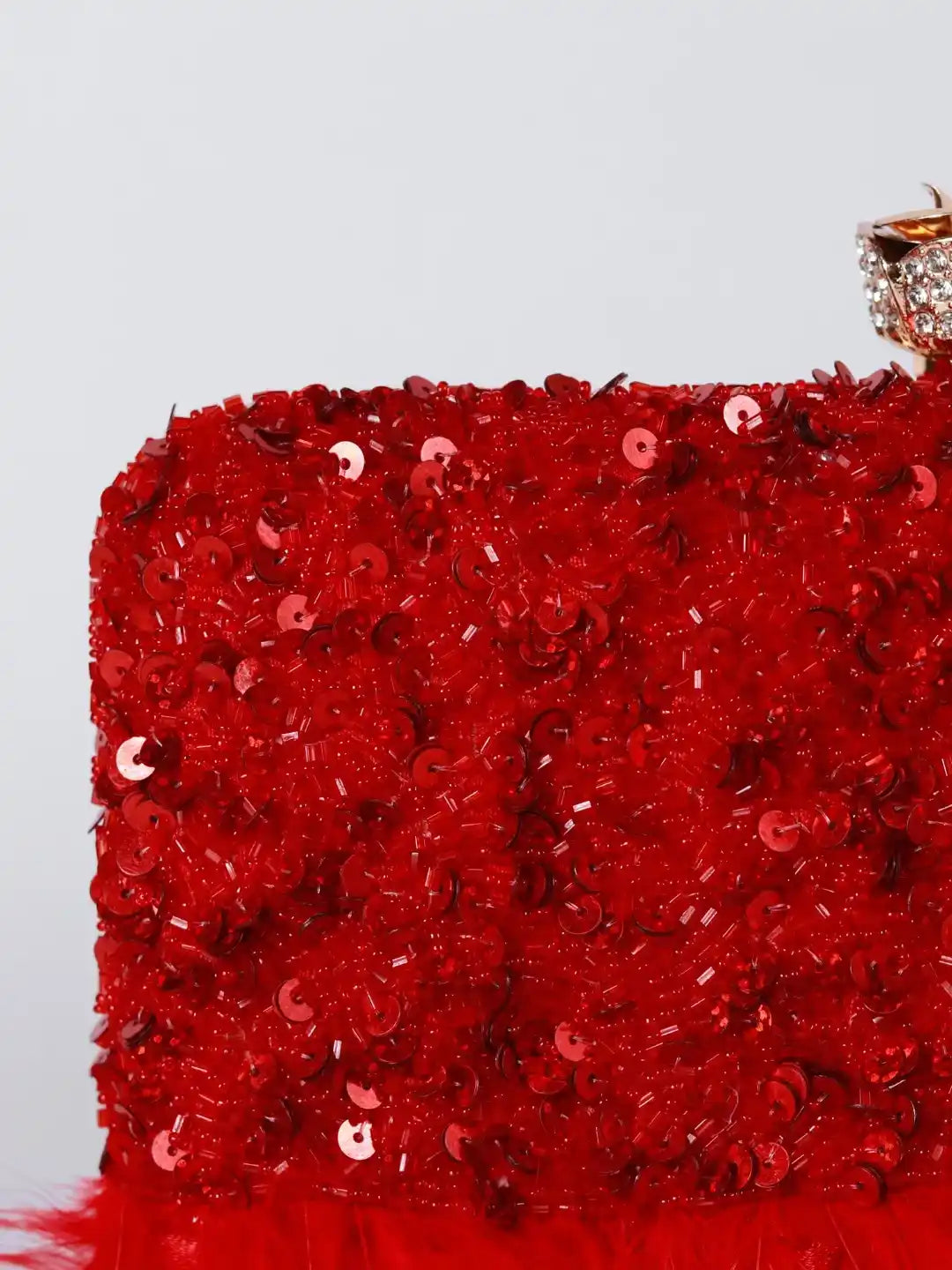 Red Daina hand-embroidered feather clutch bag with intricate detailing, crafted by The Tan Clan.