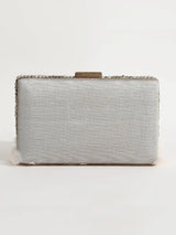 White hand-embroidered feather clutch bag with intricate detailing, designed by The Tan Clan for elegant style.