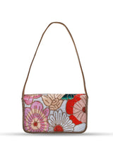 Daisy floral baguette bag with handle by The Tan Clan, featuring a colorful daisy pattern and a sleek rectangular shape.