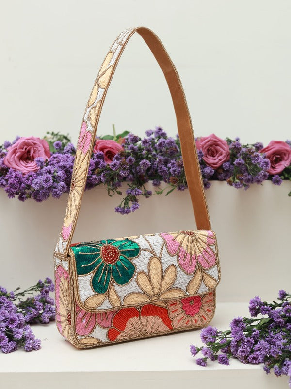 Daisy floral baguette bag with handle by The Tan Clan, featuring a colorful daisy print and a sleek, compact design.