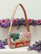 Daisy floral baguette bag with handle by The Tan Clan, featuring a colorful daisy print and a sleek, compact design.
