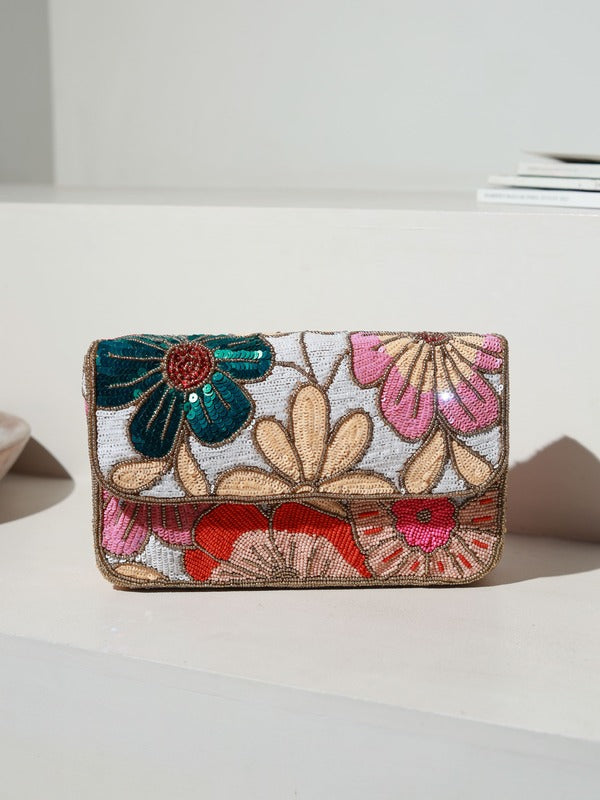 Daisy floral baguette bag with handle by The Tan Clan, featuring a colorful daisy print and a sleek, compact design.