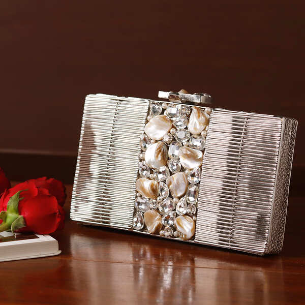 Daniya Mother of Pearl Brass Clutch by The Tan Clan featuring iridescent pearl surface and elegant brass frame.