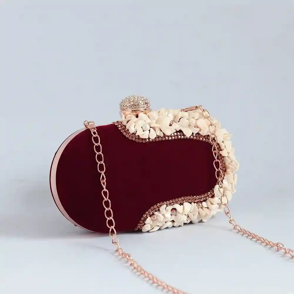 Dariya sea shell hand-embroidered clutch bag by The Tan Clan with intricate shell designs and embroidered detailing.
