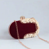 Dariya sea shell hand-embroidered clutch bag by The Tan Clan with intricate shell designs and embroidered detailing.