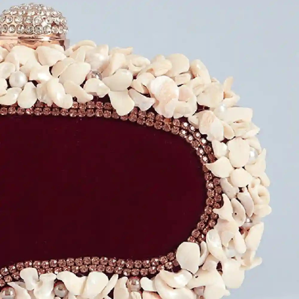 Dariya Sea Shells hand-embroidered clutch bag by The Tan Clan featuring intricate sea shell designs and vibrant embroidery.