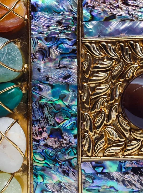 Disha Mother of Pearl Clutch by The Tan Clan featuring a shimmering pearl exterior and elegant fold-over design.