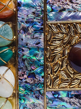 Disha Mother of Pearl Clutch by The Tan Clan featuring a shimmering pearl exterior and elegant fold-over design.