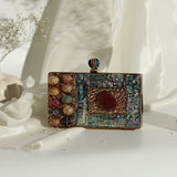 Disha Mother of Pearl Clutch by The Tan Clan featuring shimmering pearl design and elegant compact shape.