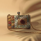 Disha Mother of Pearl Clutch by The Tan Clan featuring a shimmering pearl exterior and elegant design for special occasions.