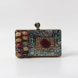 Disha Mother of Pearl Clutch by The Tan Clan featuring iridescent pearl detailing and a sleek rectangular shape.
