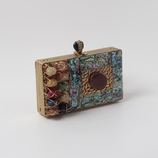 Disha Mother of Pearl Clutch by The Tan Clan with iridescent pearl finish and elegant compact design.