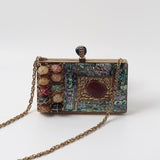 Disha Mother of Pearl Clutch by The Tan Clan featuring shimmering pearl details, sleek design, and compact size for elegant occasions.