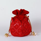 Hand-embroidered lotus-design potli bag by The Tan Clan, featuring traditional craftsmanship and intricate detailing.