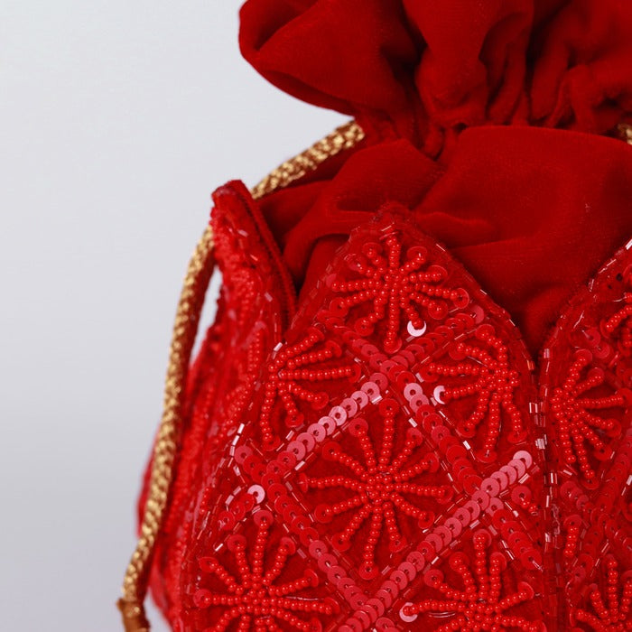 Hand-embroidered lotus design on The Tan Clan Ehsaas hand-embroidered potli bag with intricate detailing and traditional craftsmanship.