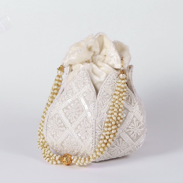 Hand embroidered lotus design on a traditional potli bag by The Tan Clan, showcasing intricate embroidery and vibrant details.