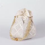 Hand embroidered lotus design on a traditional potli bag by The Tan Clan, showcasing intricate embroidery and vibrant details.