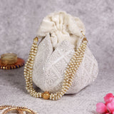 Hand-embroidered lotus-designed Ehsaas hand potli bag by The Tan Clan, showcasing intricate embroidery and traditional craftsmanship.