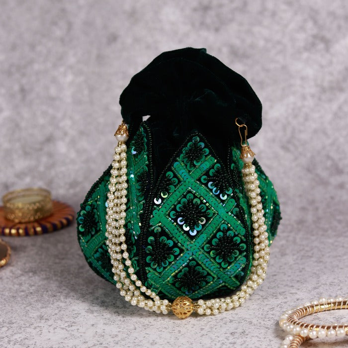 Hand-embroidered lotus design on beige fabric Ehsaas potli bag by The Tan Clan, featuring traditional craftsmanship and intricate detailing.