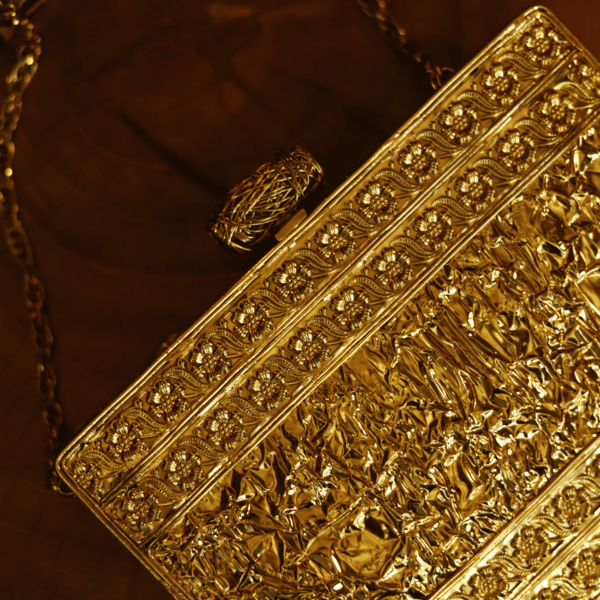 Eira Golden Embellished Brass Clutch by The Tan Clan showing a luxurious gold-tone clutch with intricate embellishments and a sleek design.