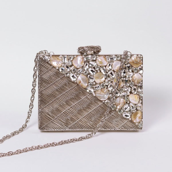 Silver embellished brass clutch bag with intricate details from The Tan Clan Eira collection, stylish for evening wear.