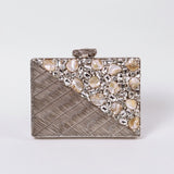 Silver brass clutch bag with intricate embellishments from The Tan Clan Eira collection, featuring a sleek, elegant design.