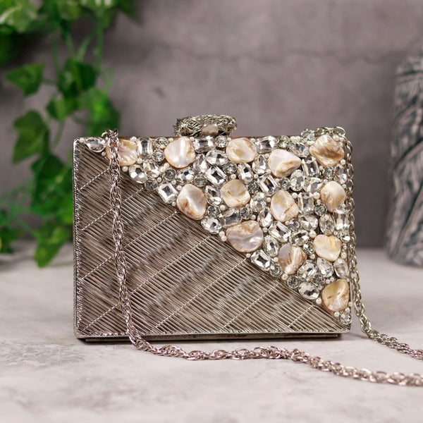 Silver embellished brass clutch bag by The Tan Clan featuring intricate details and elegant design.