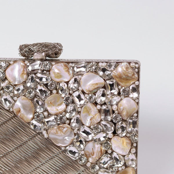 Eira Silver Embellished Brass Clutch by The Tan Clan with intricate silver embellishments and sleek brass design.