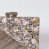 Eira Silver Embellished Brass Clutch by The Tan Clan with intricate silver embellishments and sleek brass design.