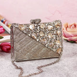 Eira silver embellished brass clutch by The Tan Clan with intricate silver details and a sleek compact design.
