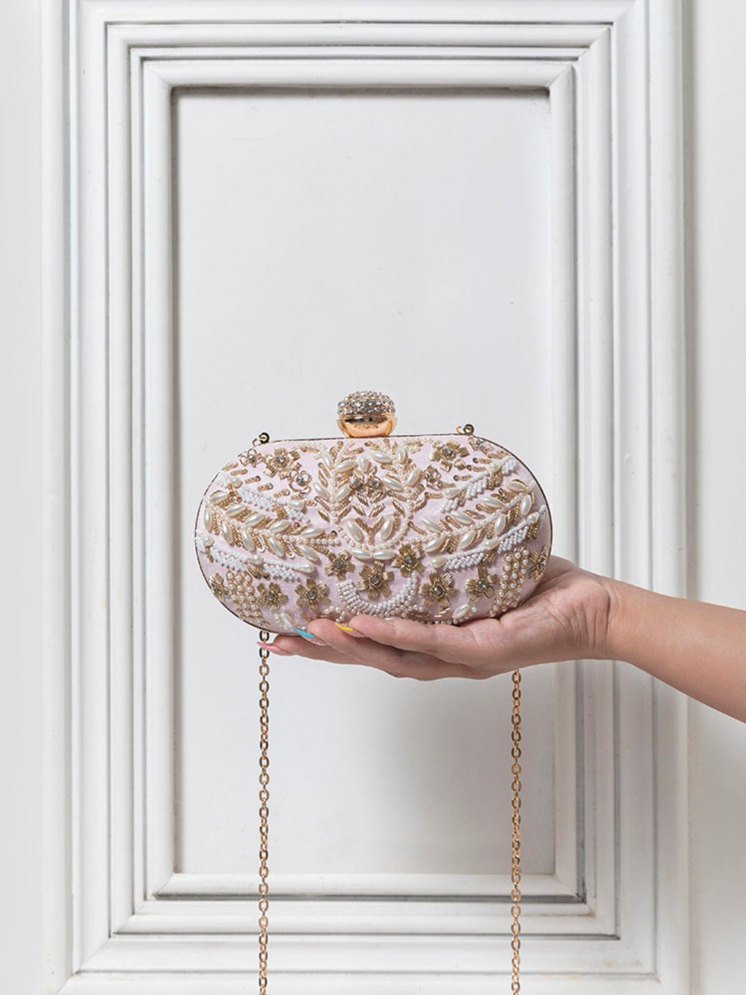 Pink Zardozi embroidered clutch bag by The Tan Clan featuring intricate hand embroidery and traditional design details.