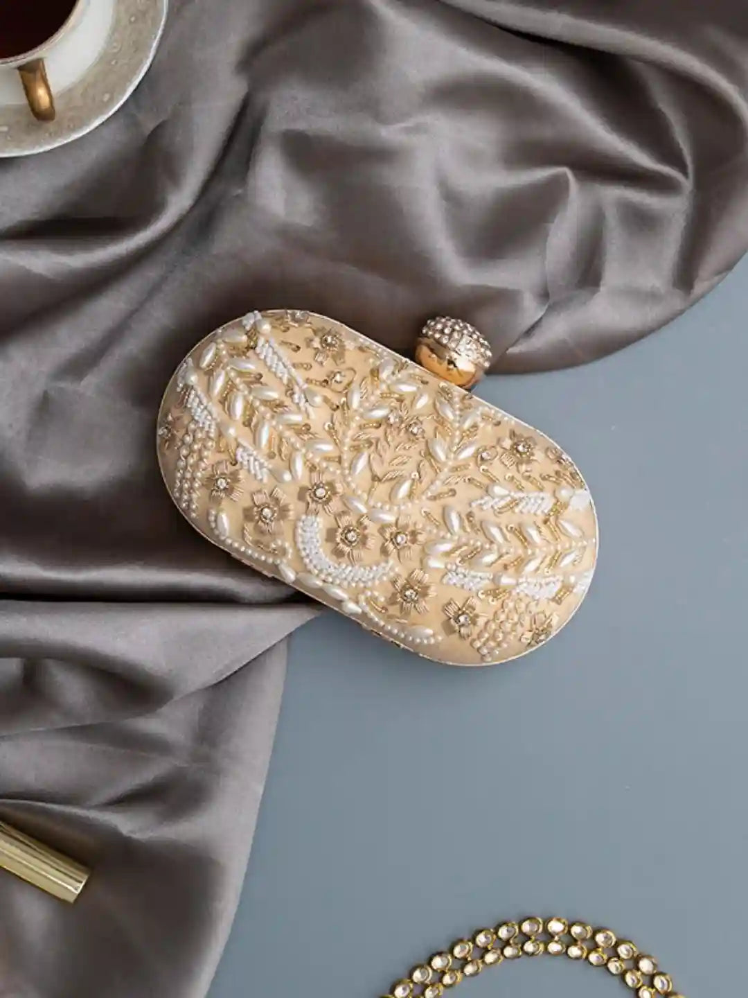 Elizah Gold Zardozi hand-embroidered clutch by The Tan Clan, featuring intricate gold needlework and traditional design details.