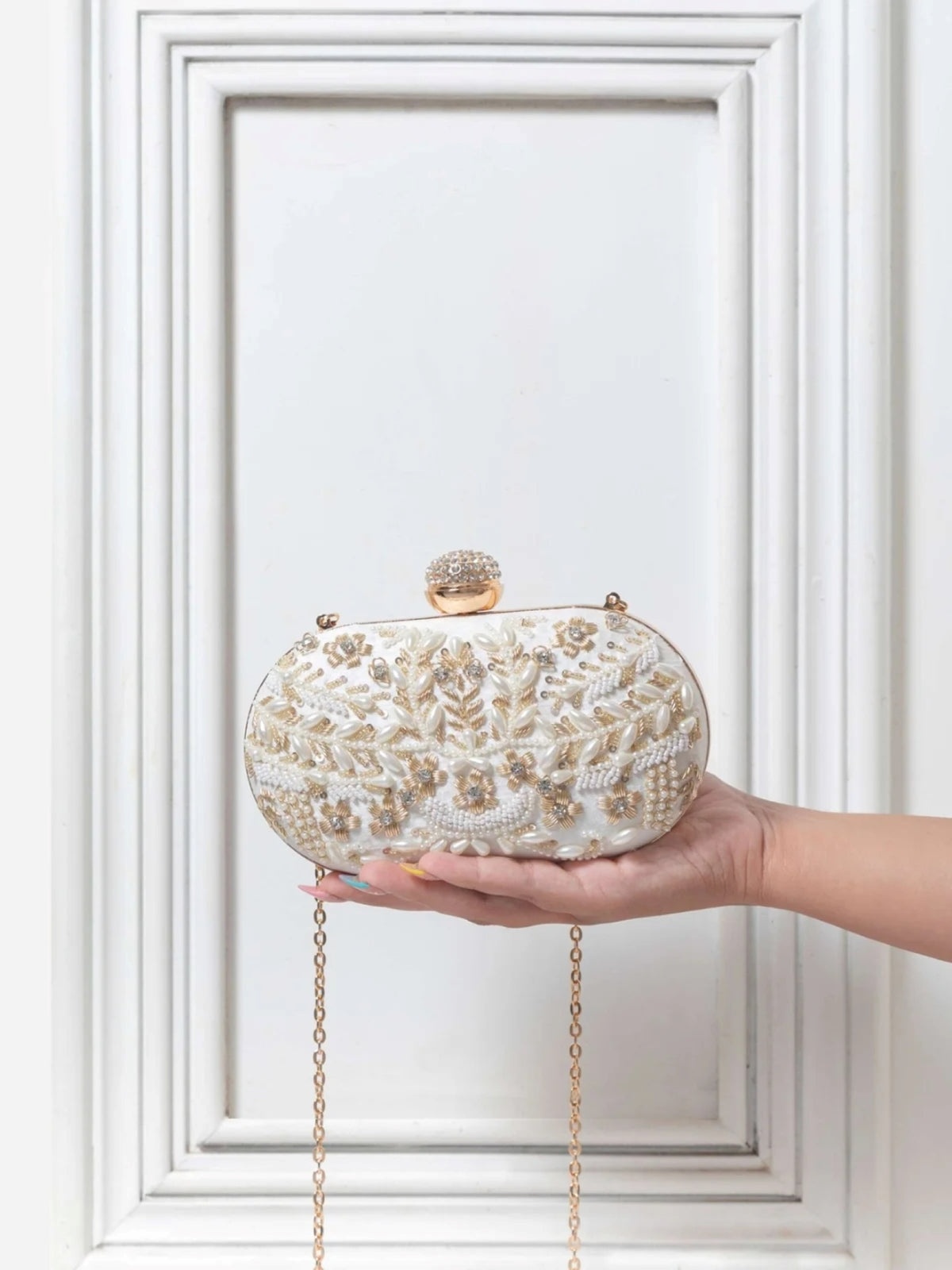 Elizah Zardozi hand-embroidered clutch featuring intricate gold thread embroidery and a sleek design, crafted by The Tan Clan.