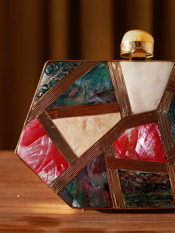 Emily multicolor mother of pearl clutch by The Tan Clan, showcasing a shimmering iridescent surface and elegant design.