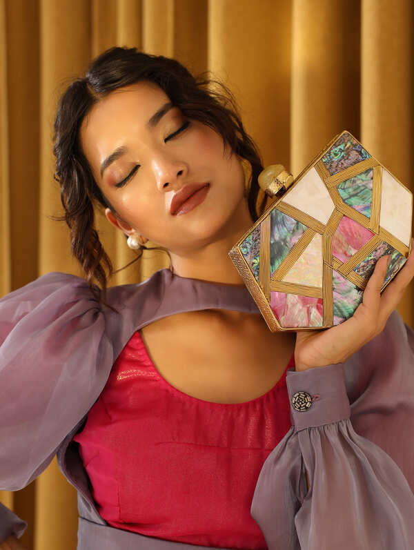 Multicolor Mother of Pearl Emily clutch by The Tan Clan featuring a sleek, elegant design with iridescent finish.
