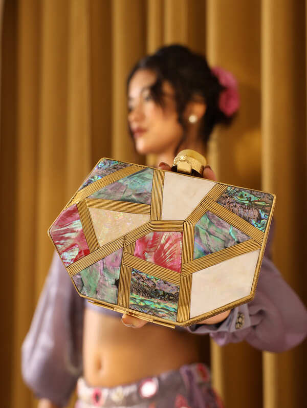 Multicolor mother of pearl clutch bag by The Tan Clan, featuring a shiny, iridescent surface and elegant rectangular shape.
