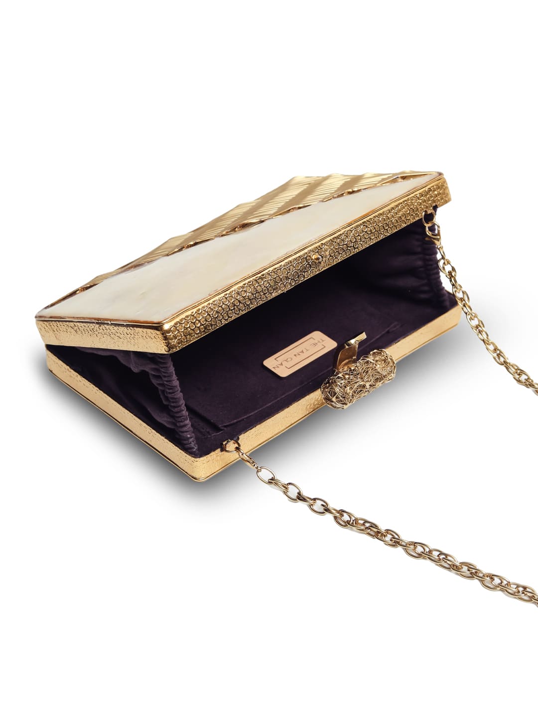 Erum golden embellished brass clutch with intricate design and decorative accents, stylish accessory for special occasions.