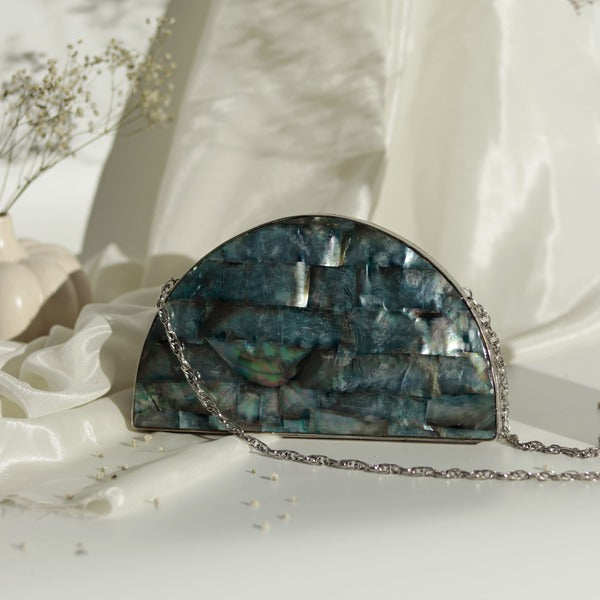 Eyan Mother of Pearl Clutch by The Tan Clan featuring a shimmering pearl finish and elegant design for stylish occasions.