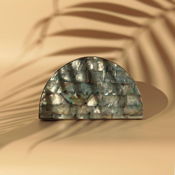 Eyan Mother of Pearl Clutch by The Tan Clan featuring iridescent mother of pearl exterior and elegant design.