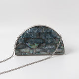 Eyan Mother of Pearl Clutch by The Tan Clan featuring a shimmering pearl exterior and elegant design.