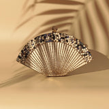 Faiza embellished mother of pearl clutch by The Tan Clan with intricate detailing and elegant design for evening events.