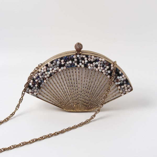 Faiza embellished mother of pearl clutch by The Tan Clan with intricate beadwork and a sleek, elegant design.