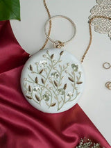 White round clutch bag with intricate hand embroidery from The Tan Clan, featuring a stylish compact design and elegant craftsmanship.