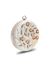 White round clutch bag with intricate hand embroidery from The Tan Clan, featuring a compact design and elegant craftsmanship.